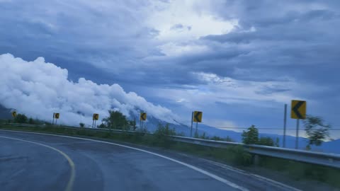 mixkit-going-down-a-curved-highway-through-a-mountain-range-41576-hd-ready